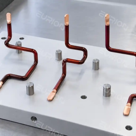 Three-phase motor stator lead wires positioned on an inspection fixture